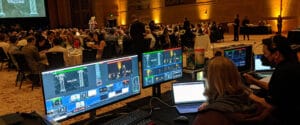 The AV Department event production team livestreams a fundraising gala. Tips to improve your hybrid event include creating separate experiences for both audiences.