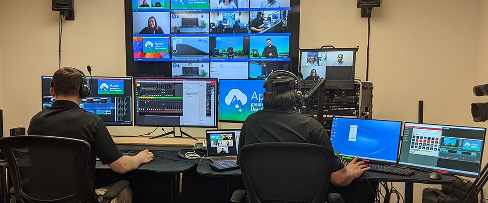 A director and streamer manage virtual event production from a control room