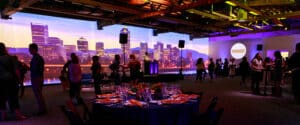 The signature 85-foot projection wall at AVENUE PORTLAND displays a skyline image during the venue's launch party