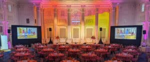 A gradient of color from yellow, to orange, to red table linens is repeated in the event lighting design in the Sentinel Governor Ballroom